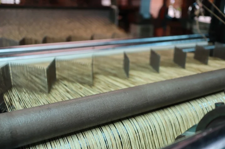 細い繊維状の素材が機械で加工されている様子