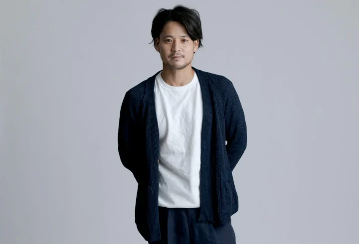 紺色のカーディガンと白いTシャツを着た男性のポートレート