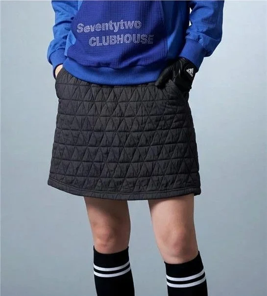 青いスウェットと黒いキルティングミニスカートを着用した人物の画像