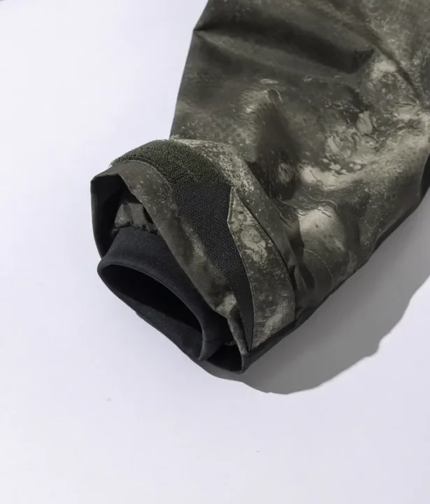 カーキ色とグレーの迷彩柄のようなアウターの袖部分