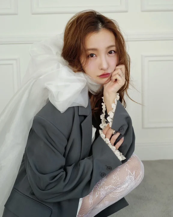 グレーのジャケットとレースタイツの女性
