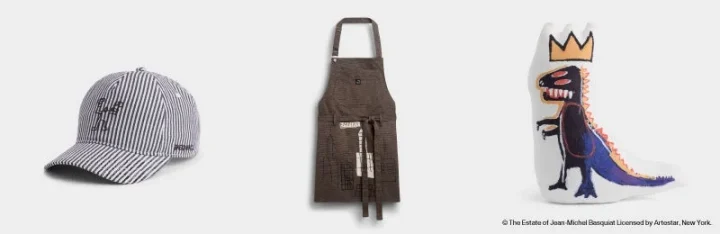 バスキアのアートが施されたキャップ、エプロン、恐竜のクッション