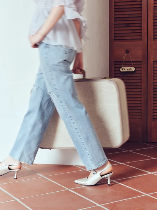 水色のダメージジーンズとフリルブラウスのウォーキングショット