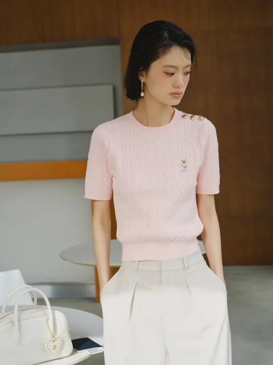 ピンクのケーブルニットの女性