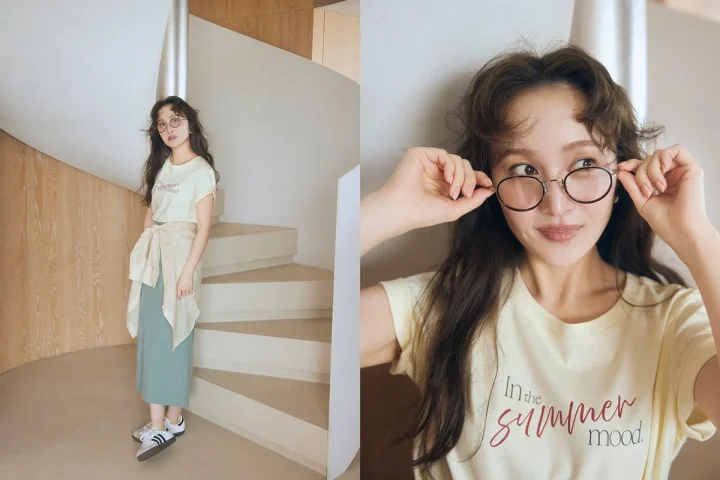 Tシャツとミントグリーンのスカートを着用し眼鏡をかけた女性
