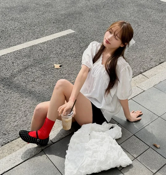 道端に座ってリラックスしている若い女性のポートレート