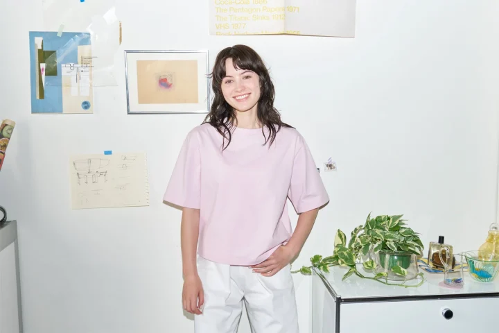 ピンクのTシャツと白いパンツを着た若い女性