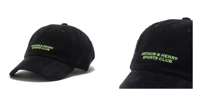 黒いコーデュロイ素材のキャップが写っており、フロントにはネオングリーンの文字で「ARTHUR & HENRY SPORTS CLUB」と刺繍されています。側面には「47」のロゴも見えます。