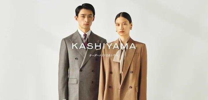 スーツを着た男女のモデルとKASHIYAMAのロゴ